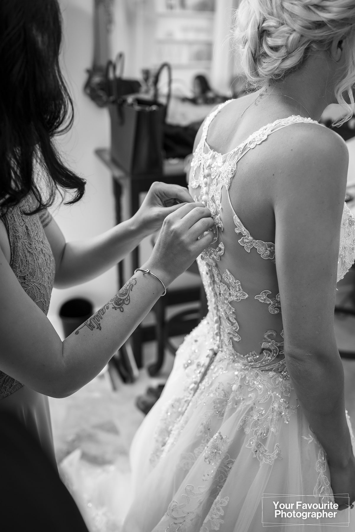 Wedding dress being buttoned up