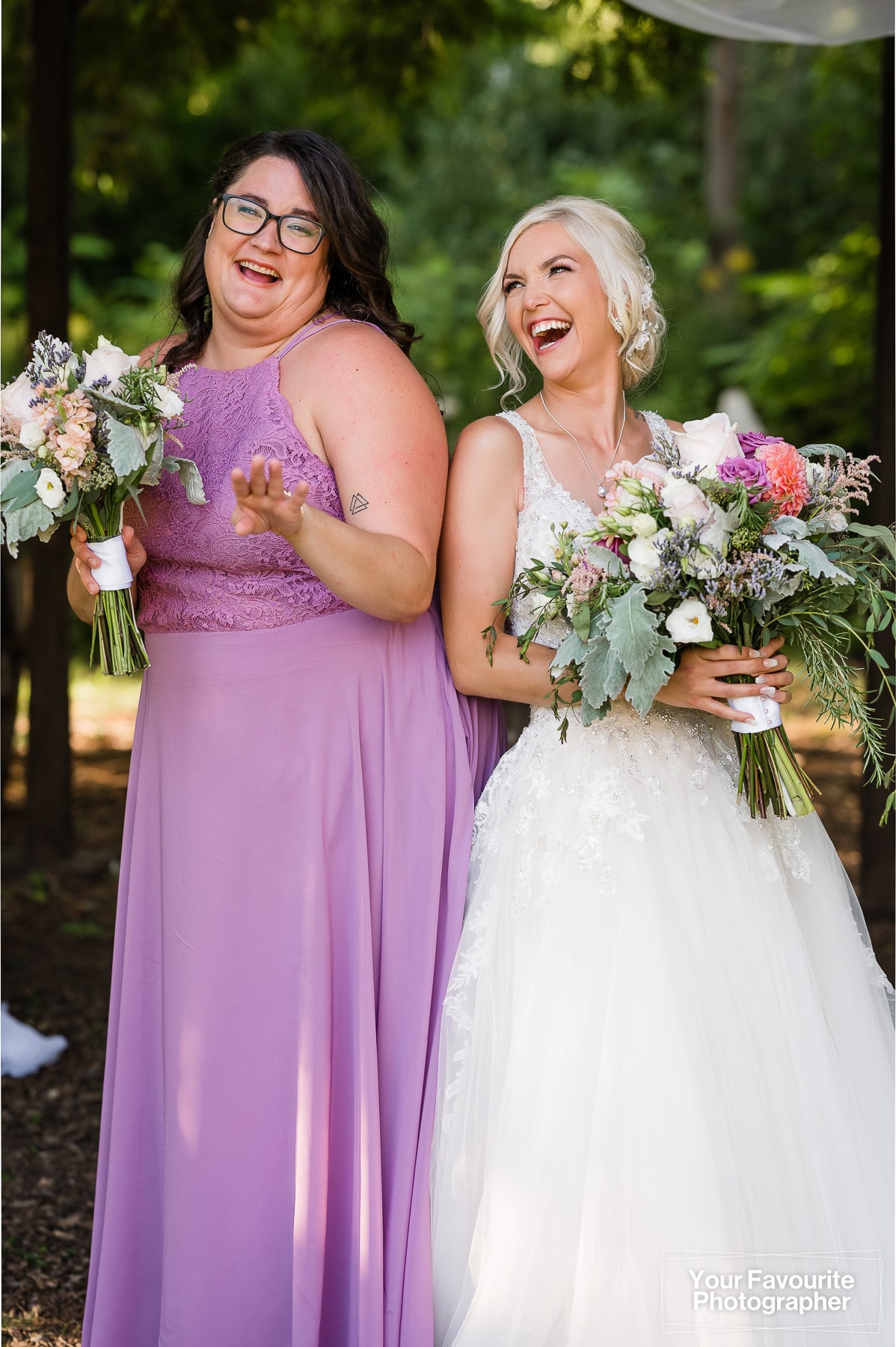 Bride and bridesmaid laughing
