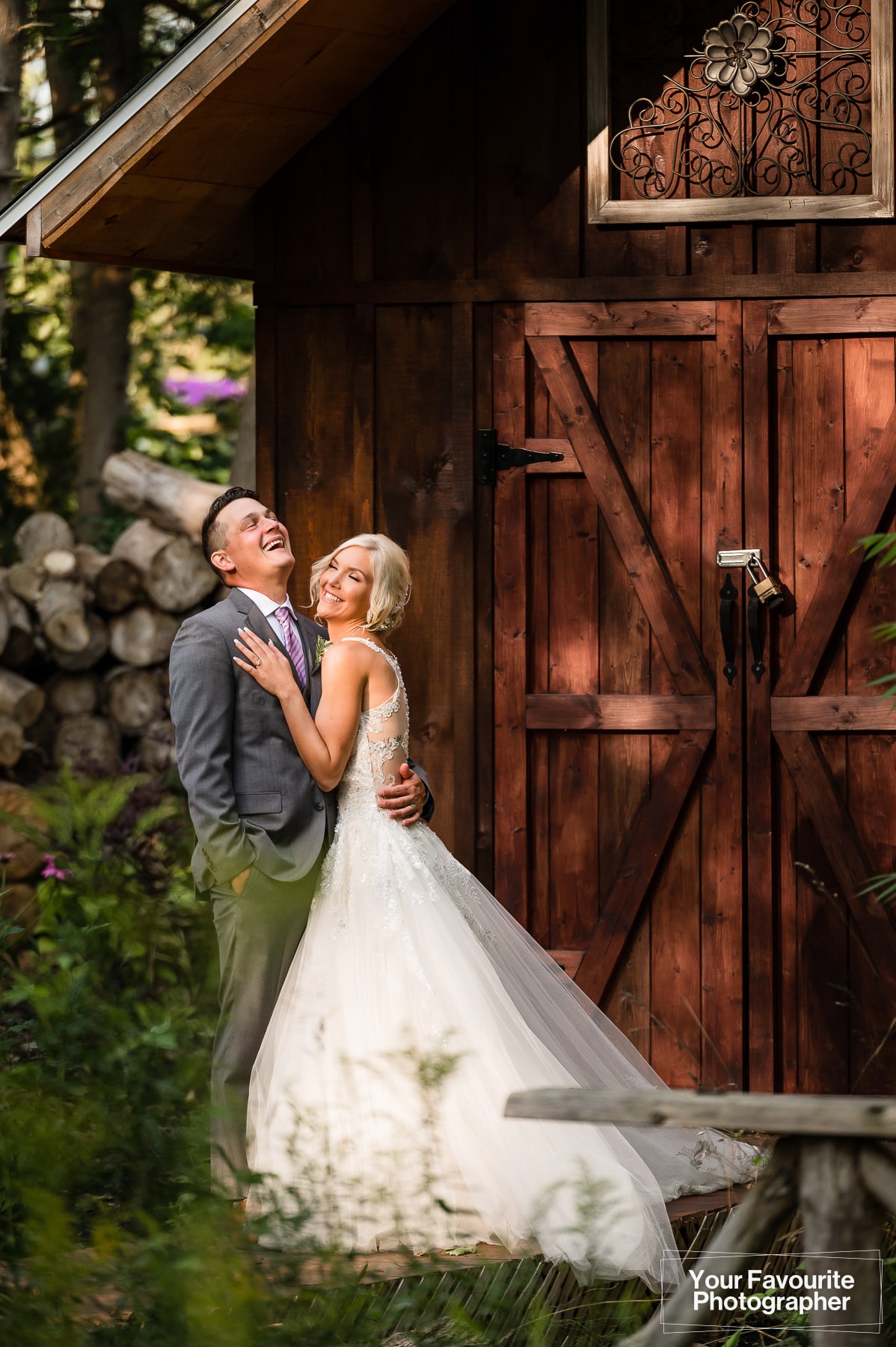 Candid laughing photo of bride and groom at rustic location