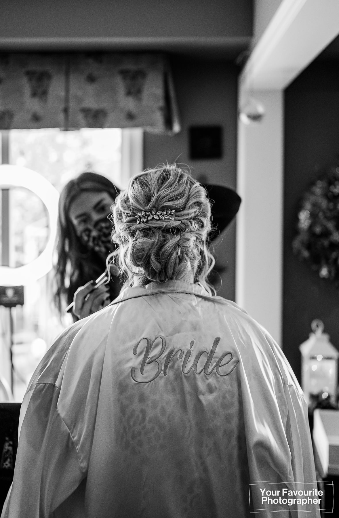 Bride getting makeup done in bridal robe