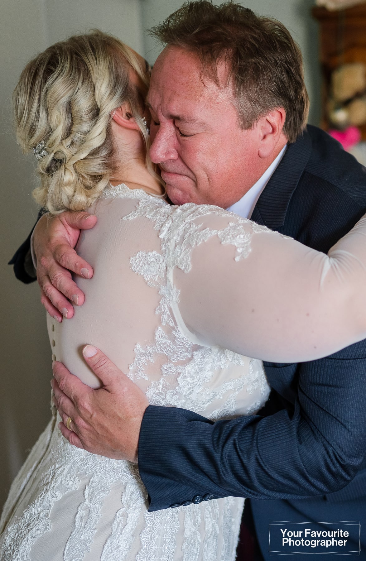 Bride and dad hugging