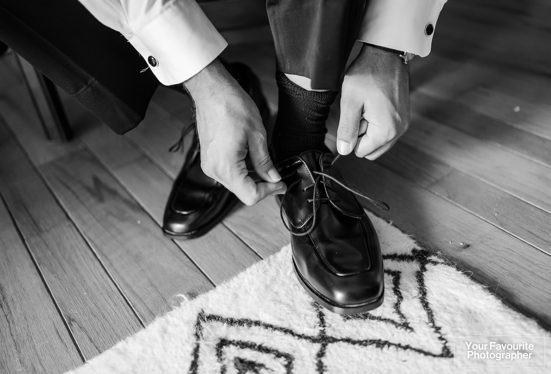 Groom tying his shoes