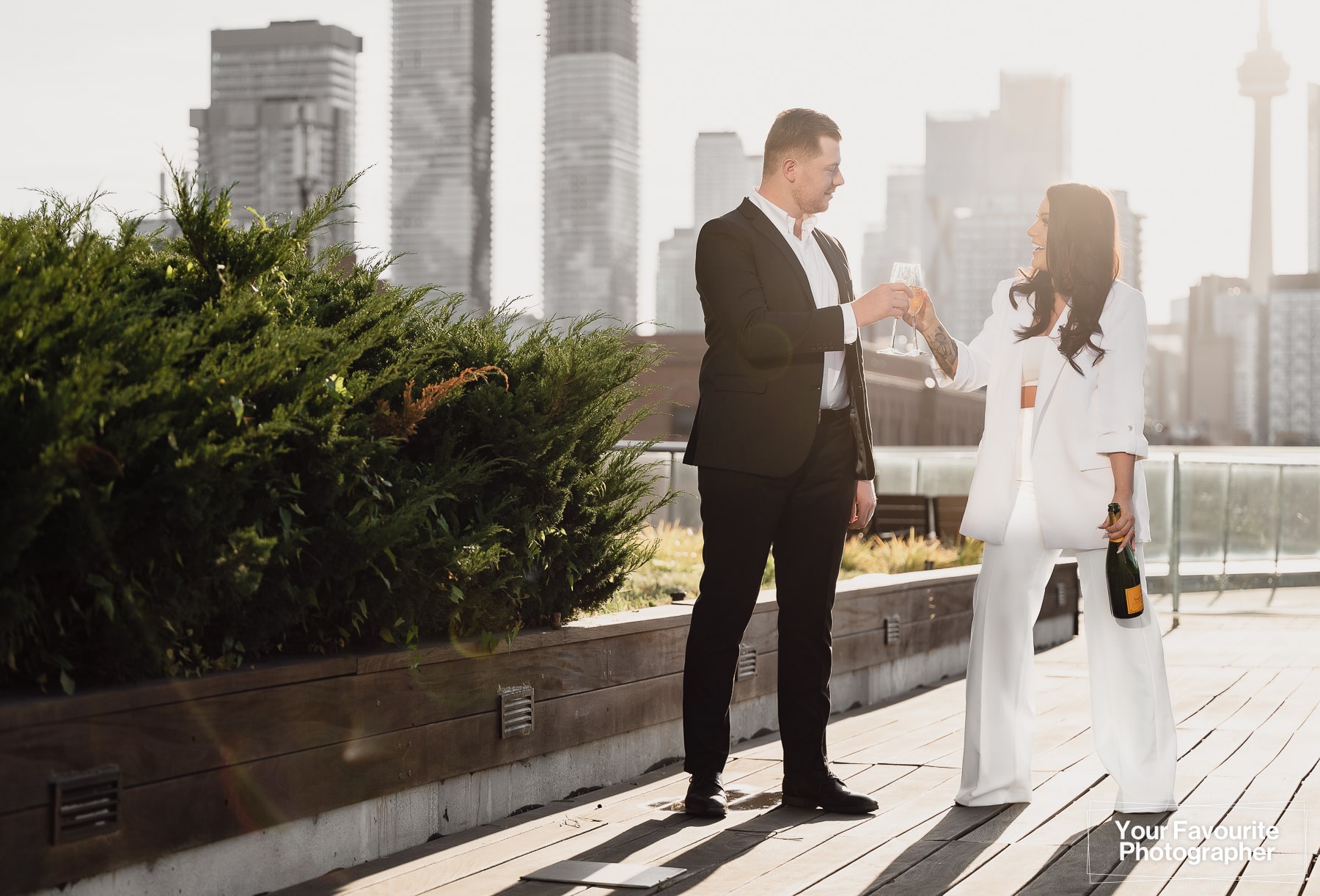 Sam and Rob celebrate their engagement with a champagne photo shoot on a downtown Toronto rooftop in the Distillery District