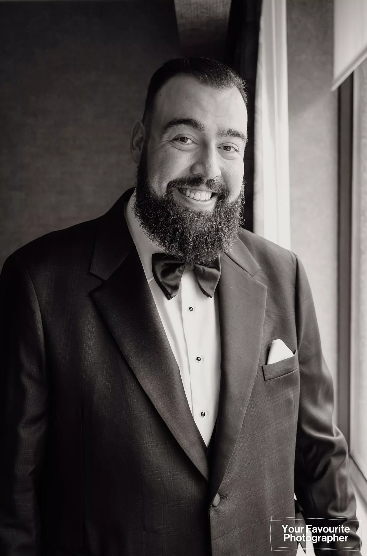 Portrait of groom Niko in black and white