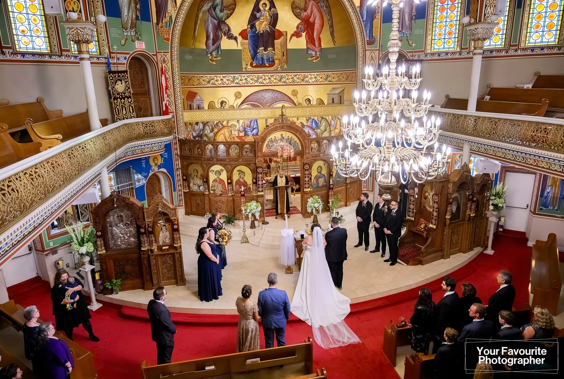 Couple getting married at St. George's Greek Orthodox Church in downtown Toronto, as seen from the balcony