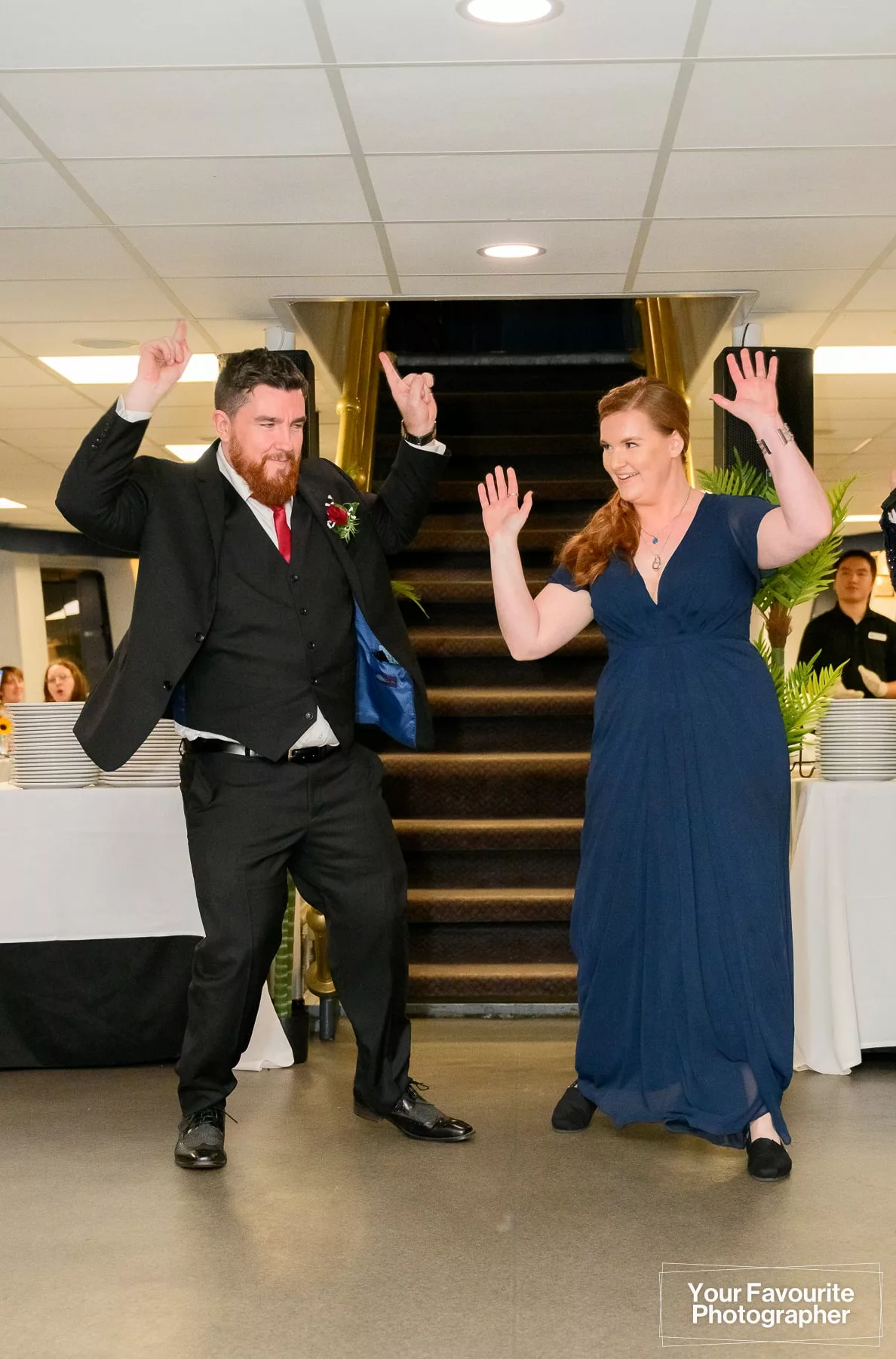 Bridesmaid and groomsman enter the reception on a boat