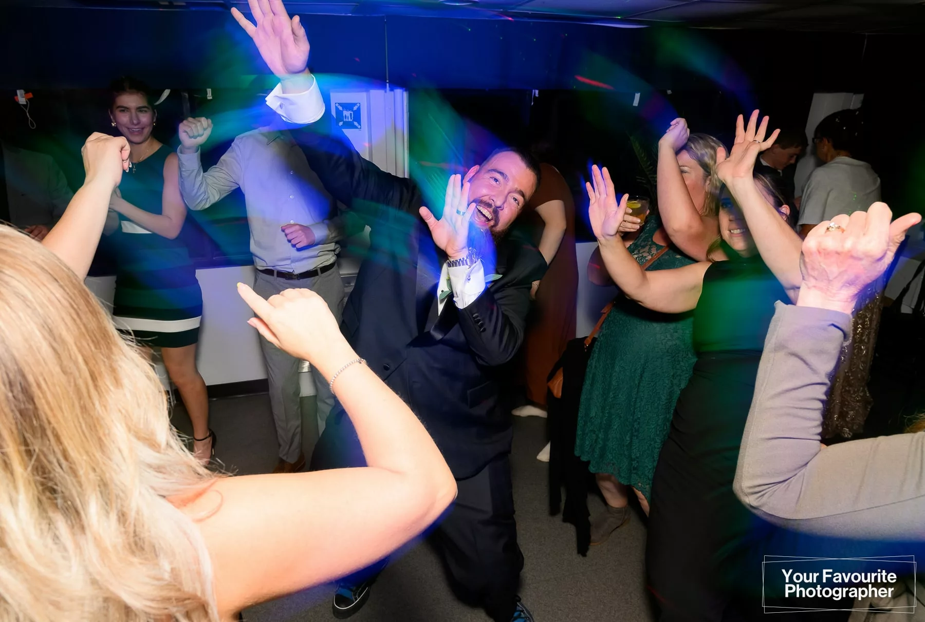 Groom dancing during a wedding reception on a boat