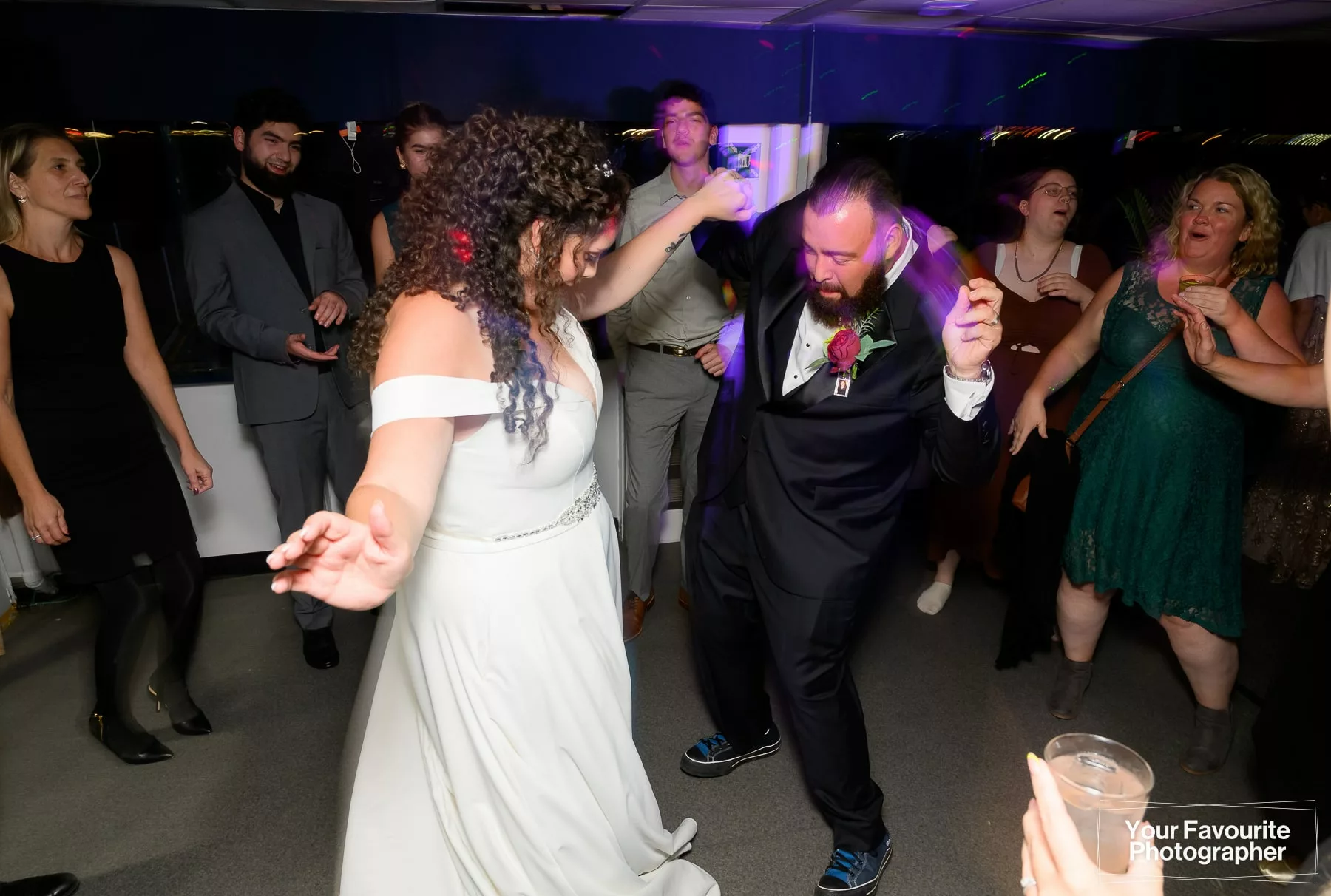 Bride and groom dancing during a wedding reception on a boat