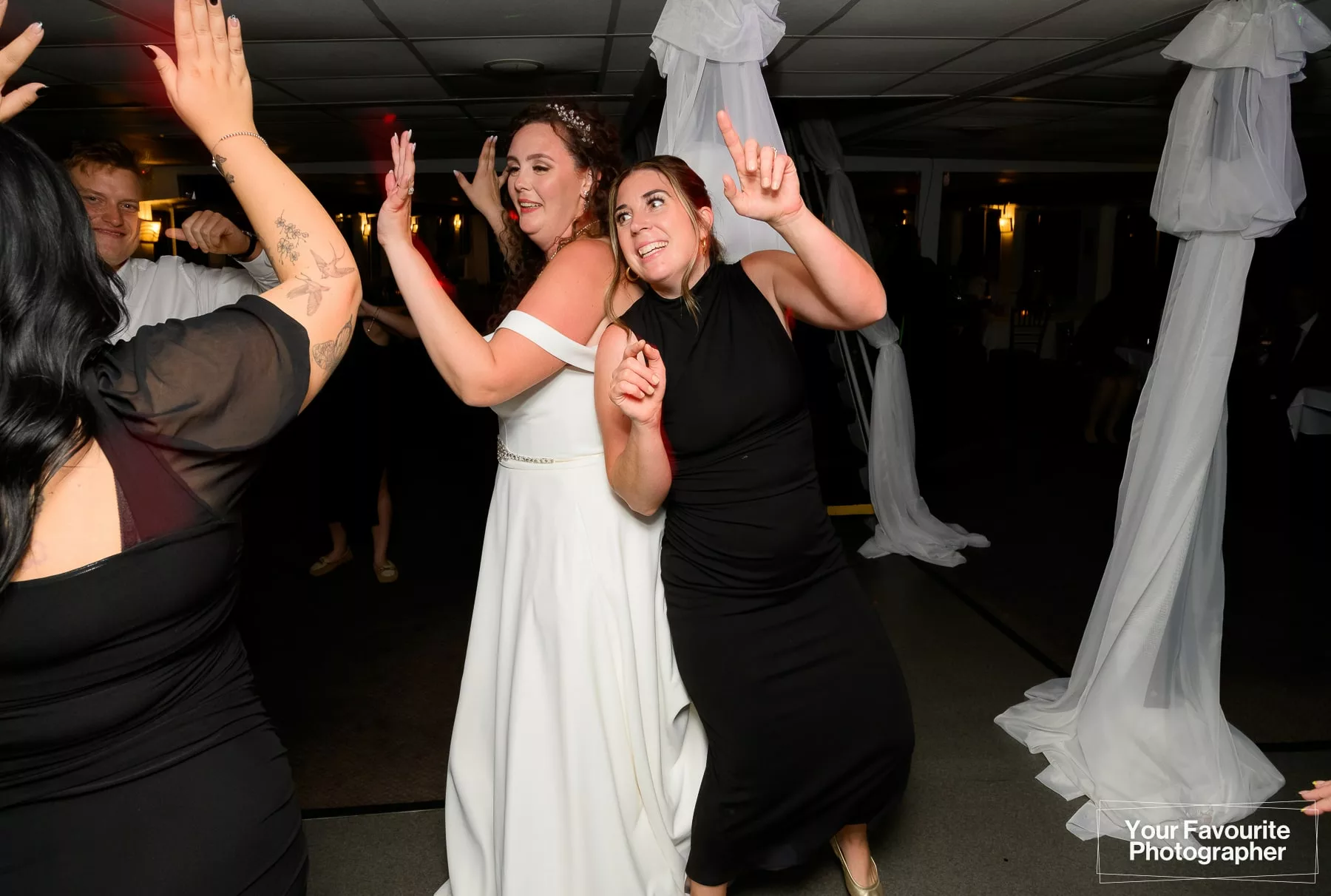Bride and guests dancing during a wedding reception on a boat