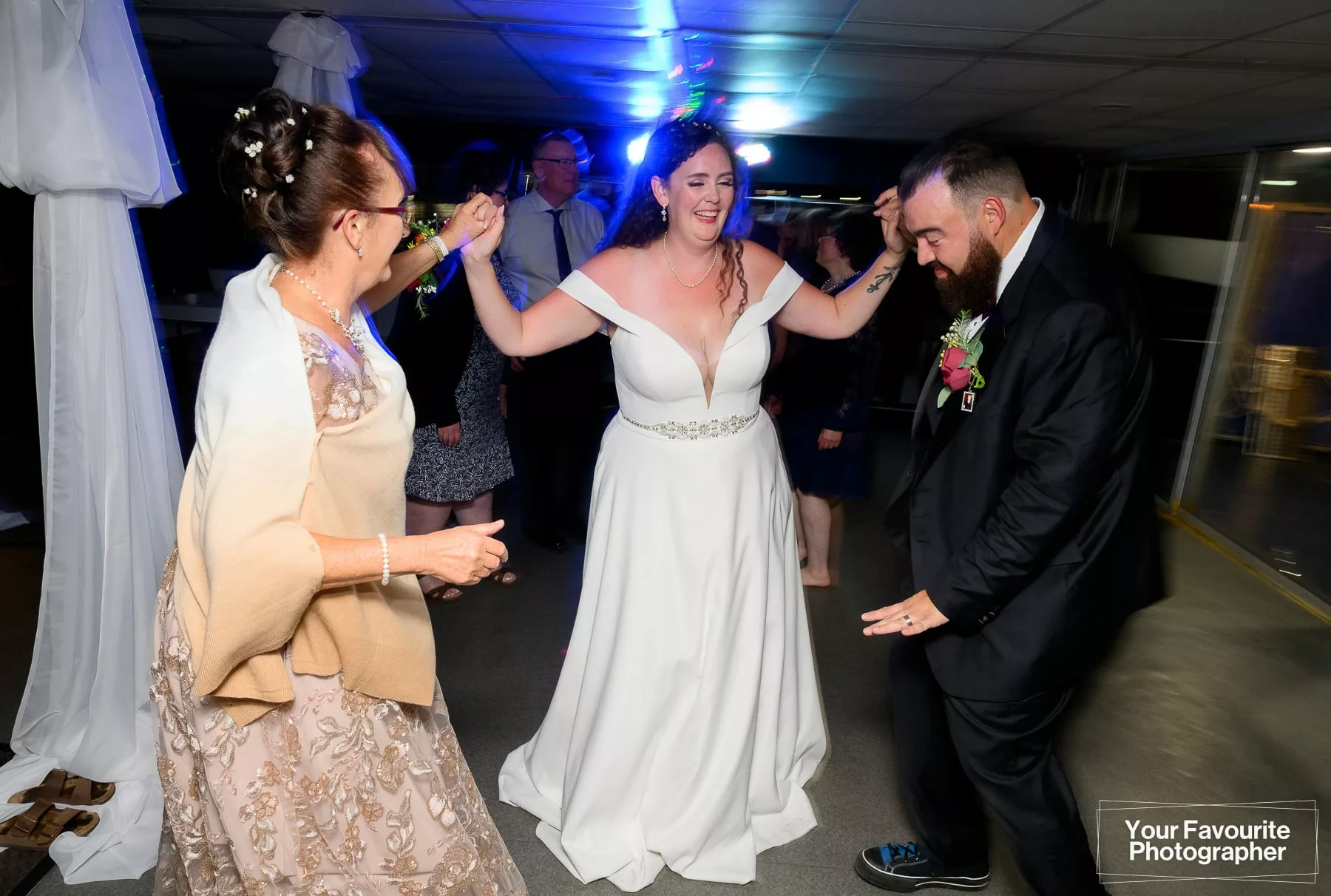 Bride and groom dancing during a wedding reception on a boat