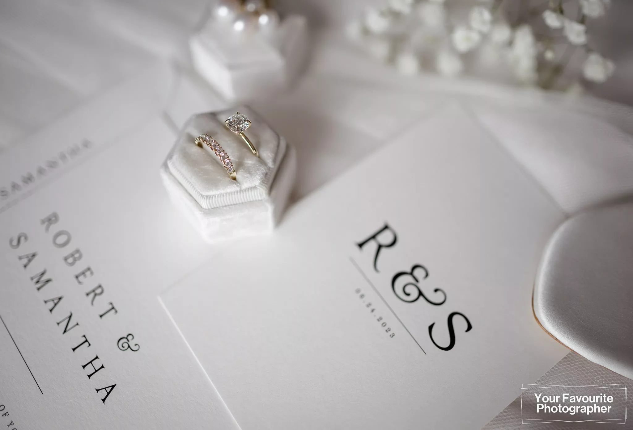 Close up of wedding rings on a wedding invitation