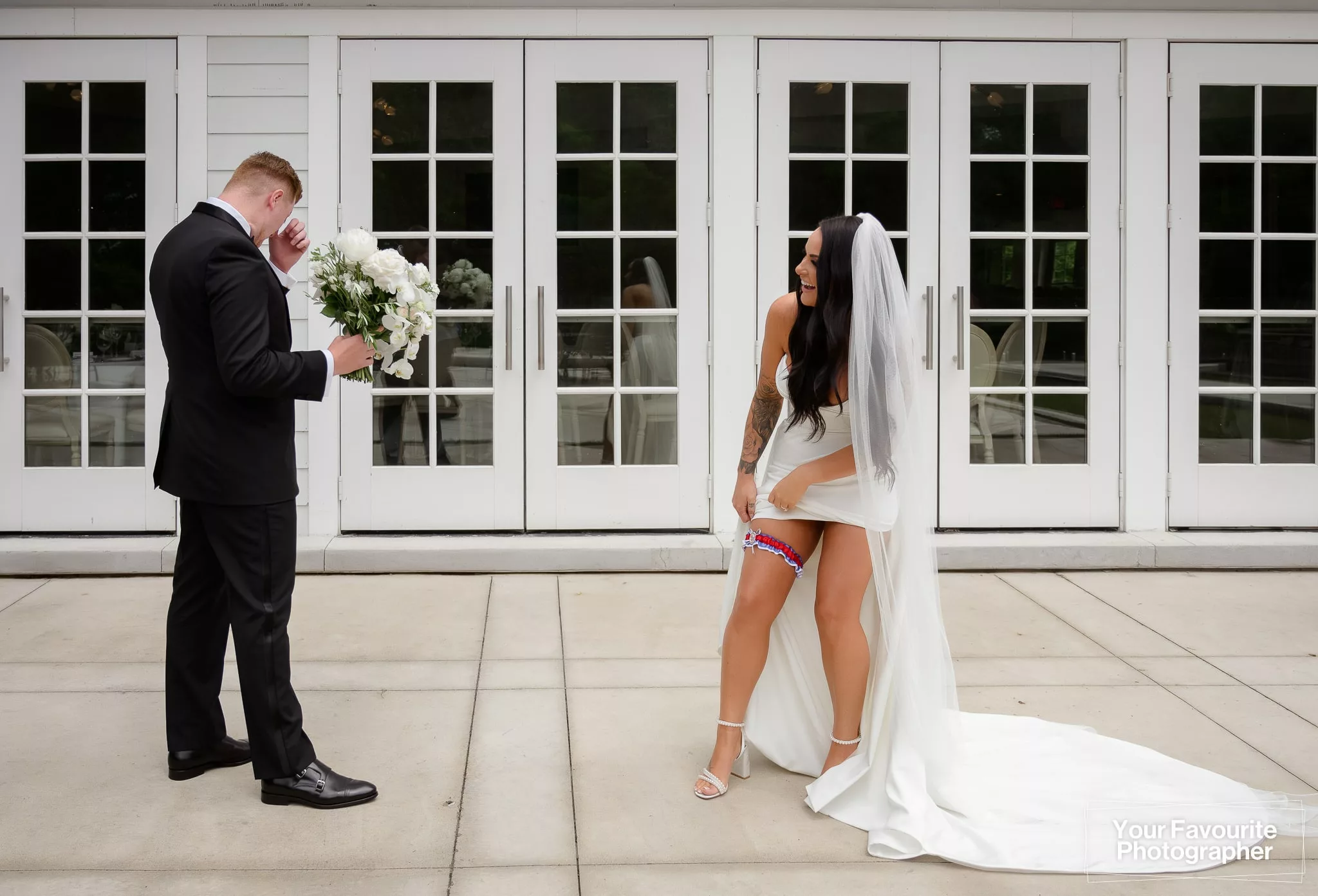 Bride laughs as she shows off her Winnipeg Jets garter for her husband