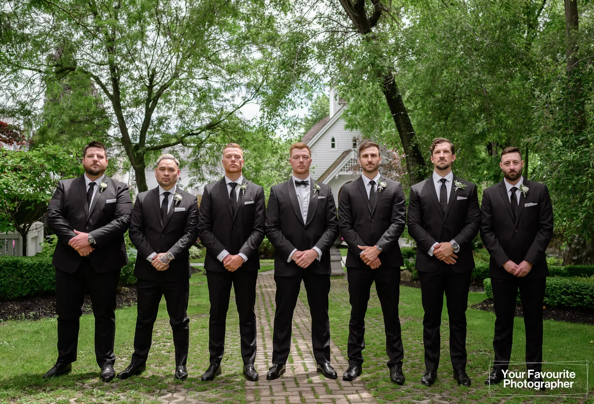Groomsmen dressed in black suits with black ties at The Doctor's House