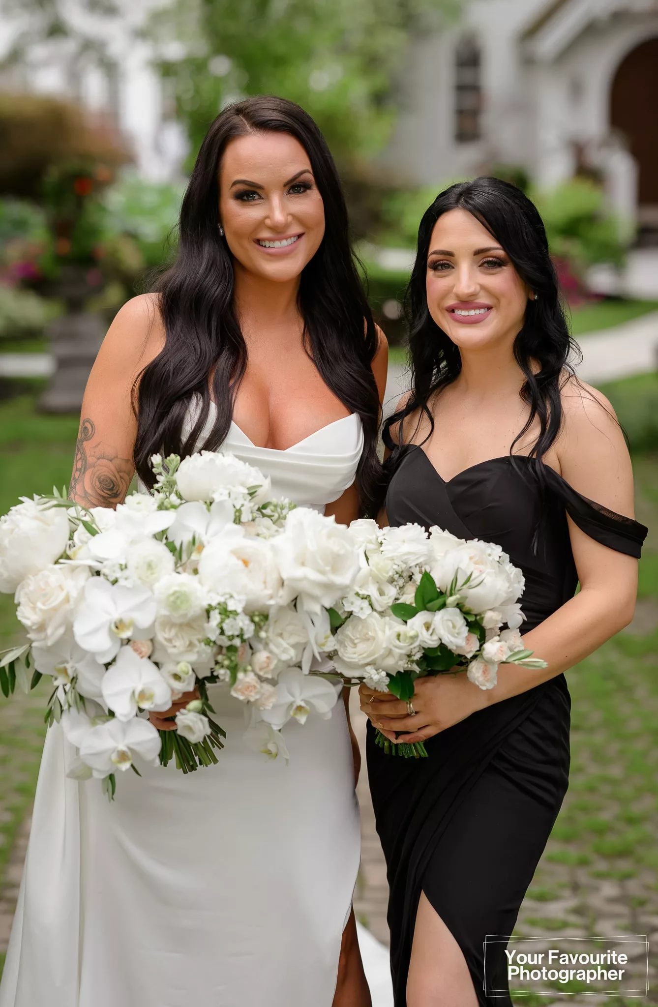 Bride with her bridesmaid in a black dress and white flowers at The Doctor's House