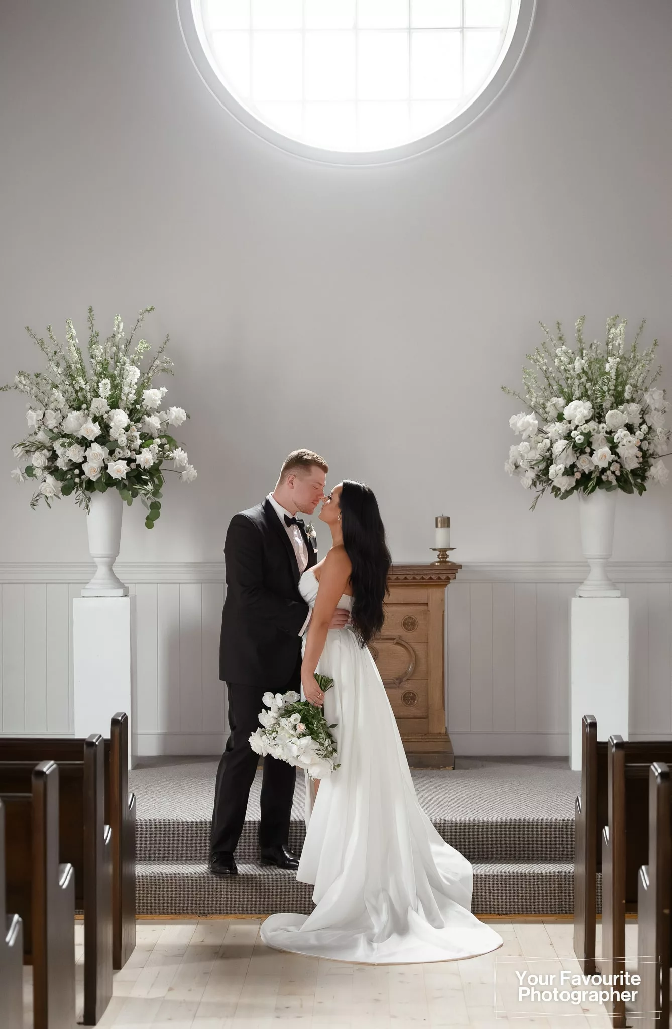 Bride and groom share a moment alone at the alter of the chapel at The Doctor's House in Kleinburg