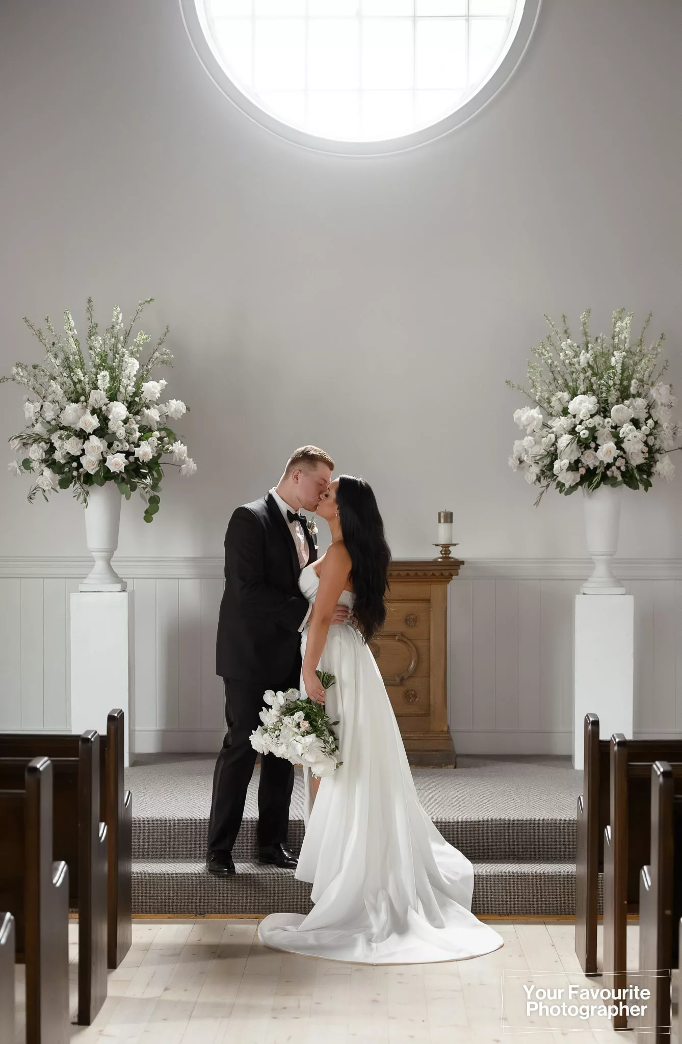 Bride and groom share a moment alone at the alter of the chapel at The Doctor's House in Kleinburg