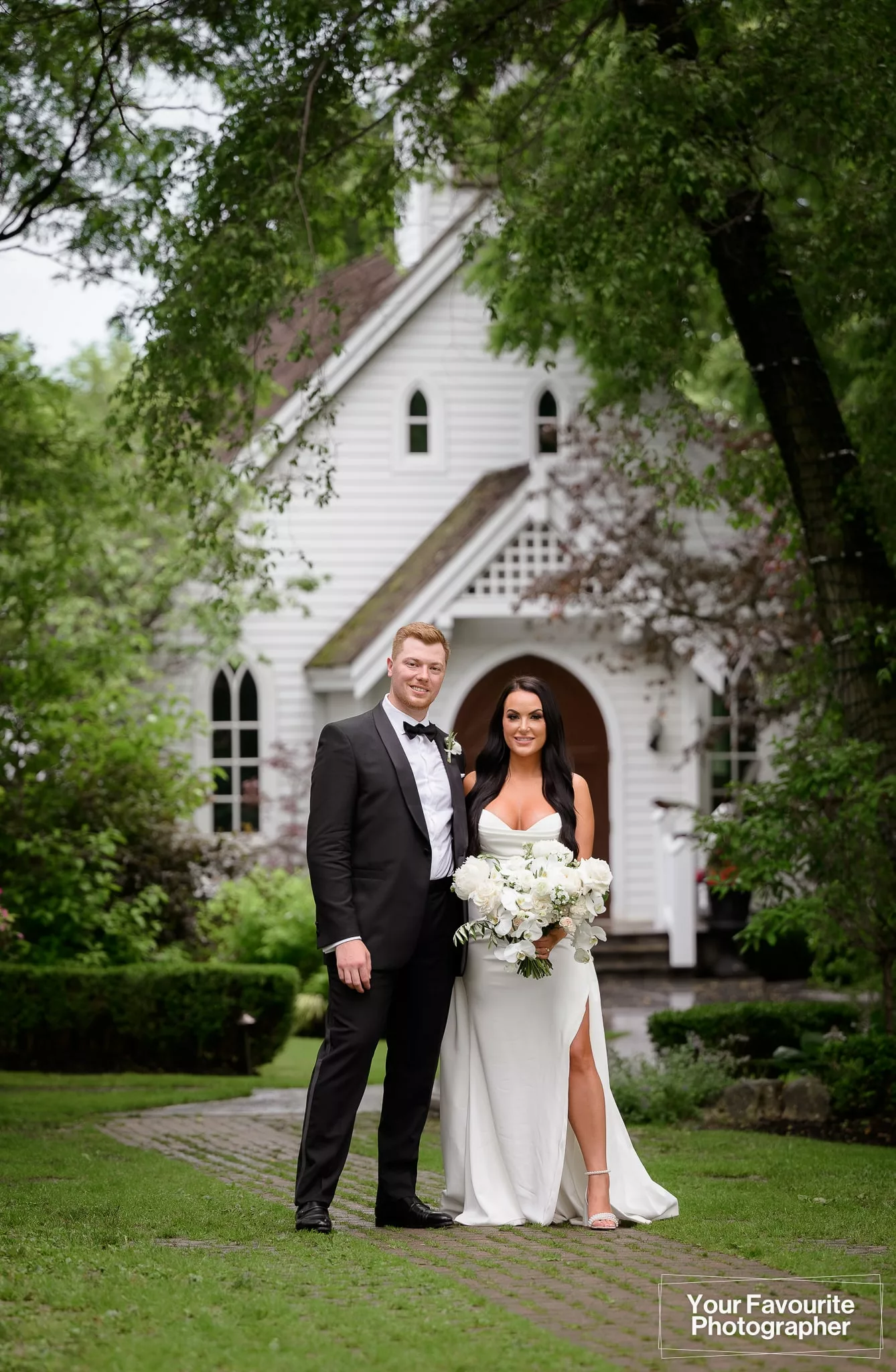 Samantha and Robert posing outside the chapel at The Doctor's House on their wedding day