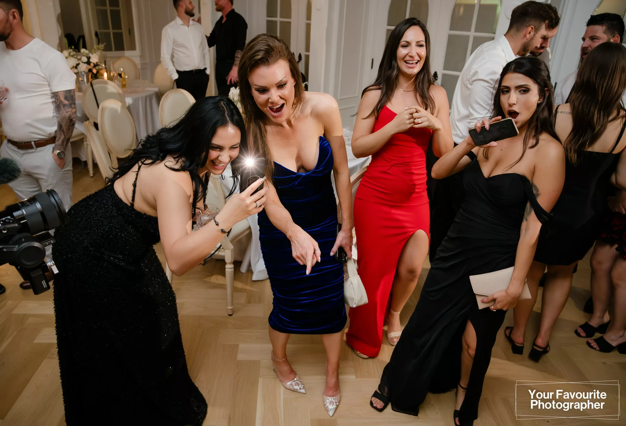 Wedding guests take photos of a funny moment
