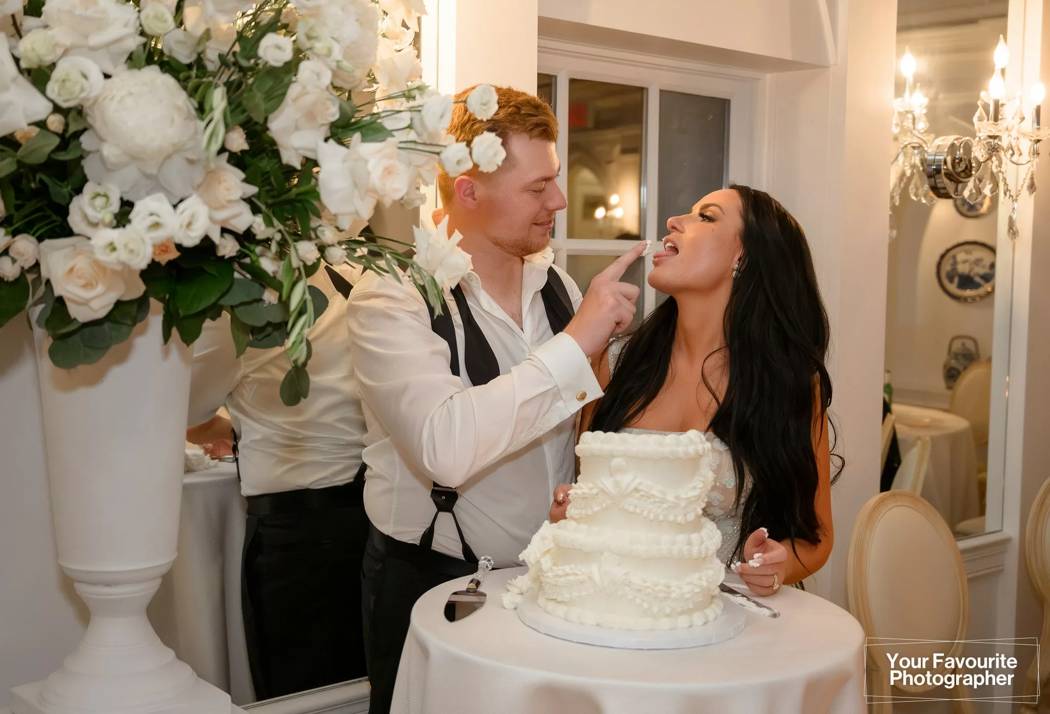 Bride and groom cutting their cake on their wedding day